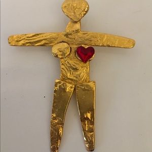 Female figure pendant.  Gold with red heart created by Joanne Cooper in 1980s